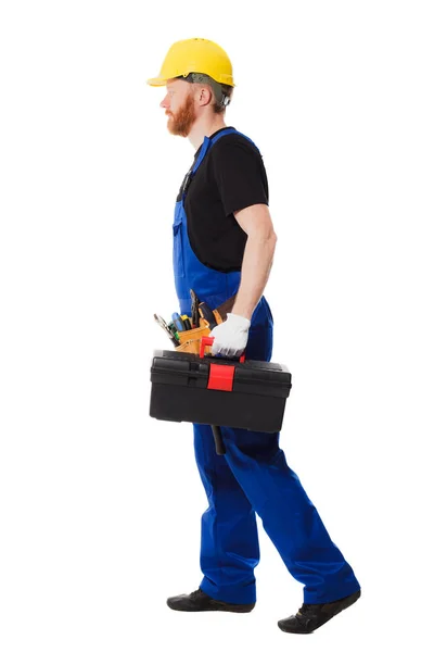 Budowniczy człowiek w mundurze posiada Skrzynka na narzędzia — Zdjęcie stockowe