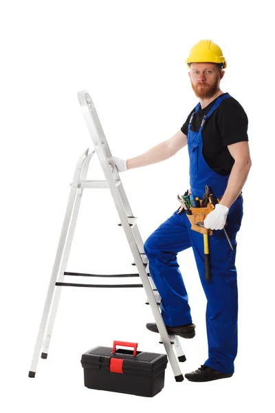 Hombre constructor en el uniforme sostiene una caja de herramientas —  Fotos de Stock