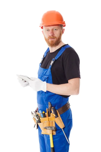 Man builder in the uniform with a tablet in the hands — Stock Photo, Image