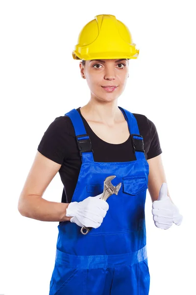 Bouwer van de vrouw in het uniform met een moersleutel — Stockfoto