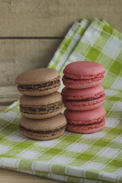 Brown and pink macarons on the plaid napkin — Stock Photo, Image