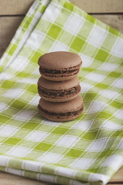 Brown macarons on the plaid napkin — Stock Photo, Image