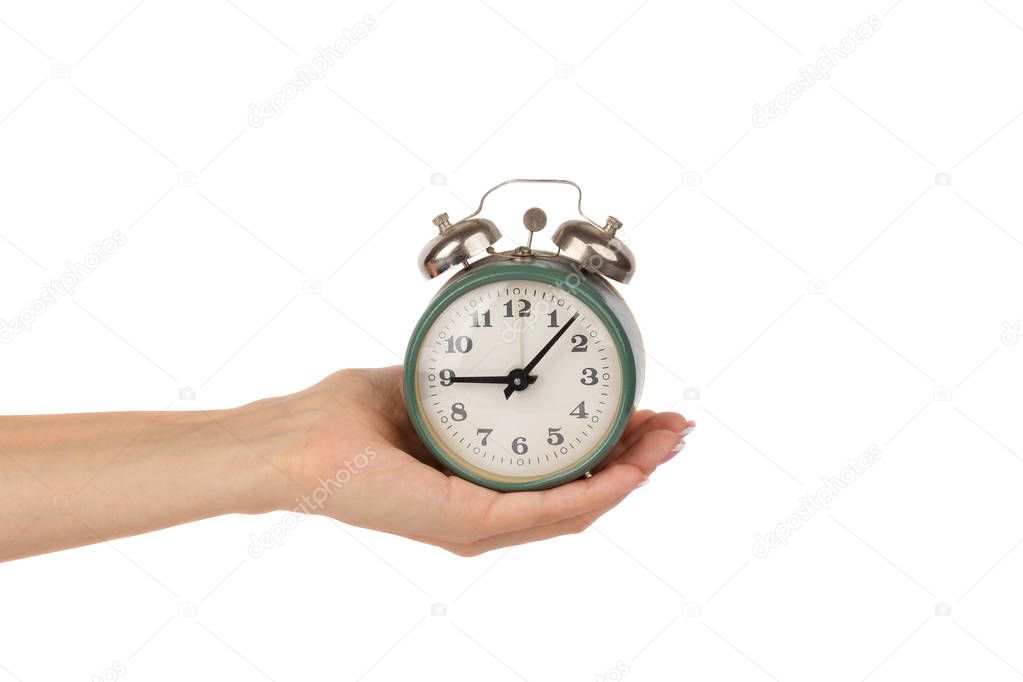 Alarm clock in the woman's hand, isolated