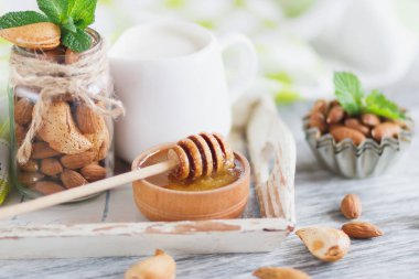 Badem, bal kase, nane yaprağı, kavanoz süt ve farklı süslemeler