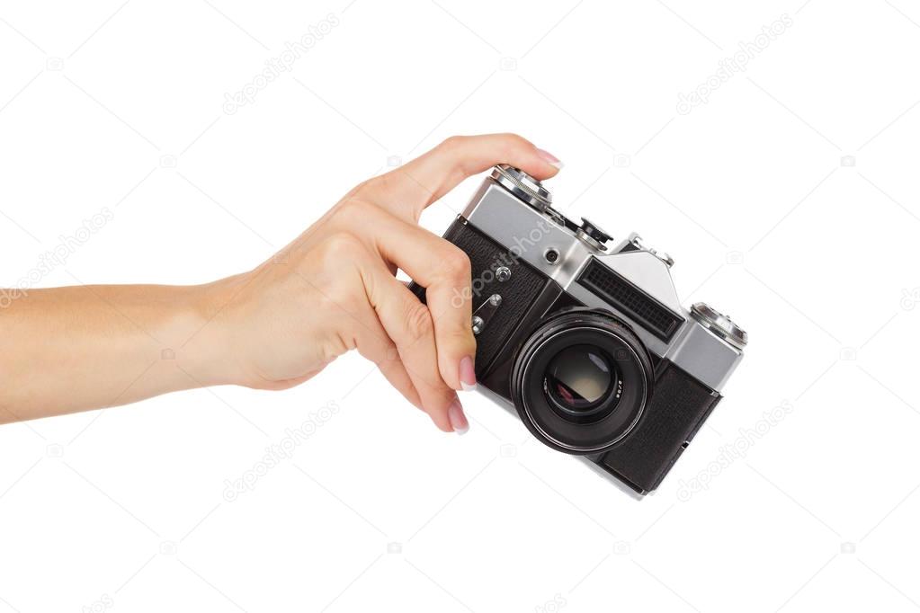 Hand holds an old photo camera, isolated