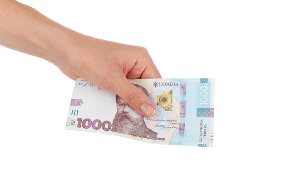Duizend hryvnia 's door één bankbiljet in de hand, geïsoleerd Stockafbeelding