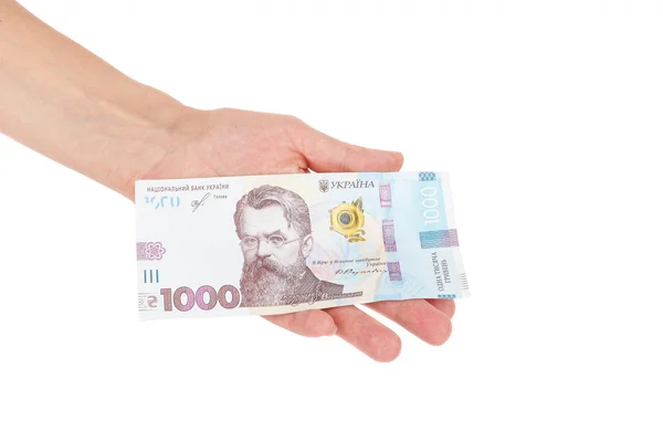 Duizend hryvnia 's door één bankbiljet in de hand, geïsoleerd Rechtenvrije Stockafbeeldingen