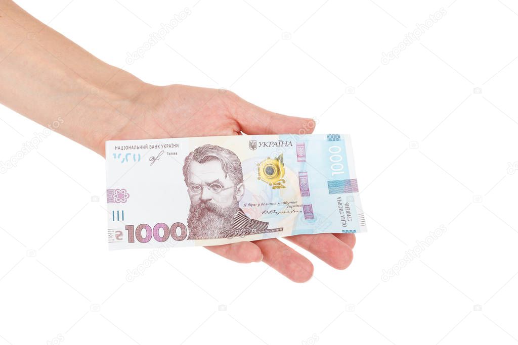 Thousand hryvnias by one banknote in the hand, isolated