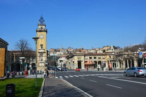 BERGAMO, ITALIA - 17 MARZO 2016: Largo Gianandrea Gavazzeni con la torre Monumento ai partigiani e la città alta sullo sfondo, Bergamo — Foto Stock