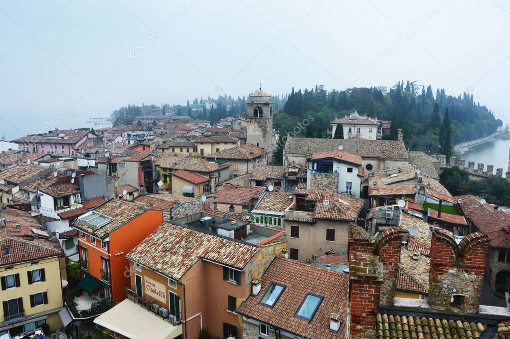 View of Sirmione town from the castle with fog Lake Garda in Italy