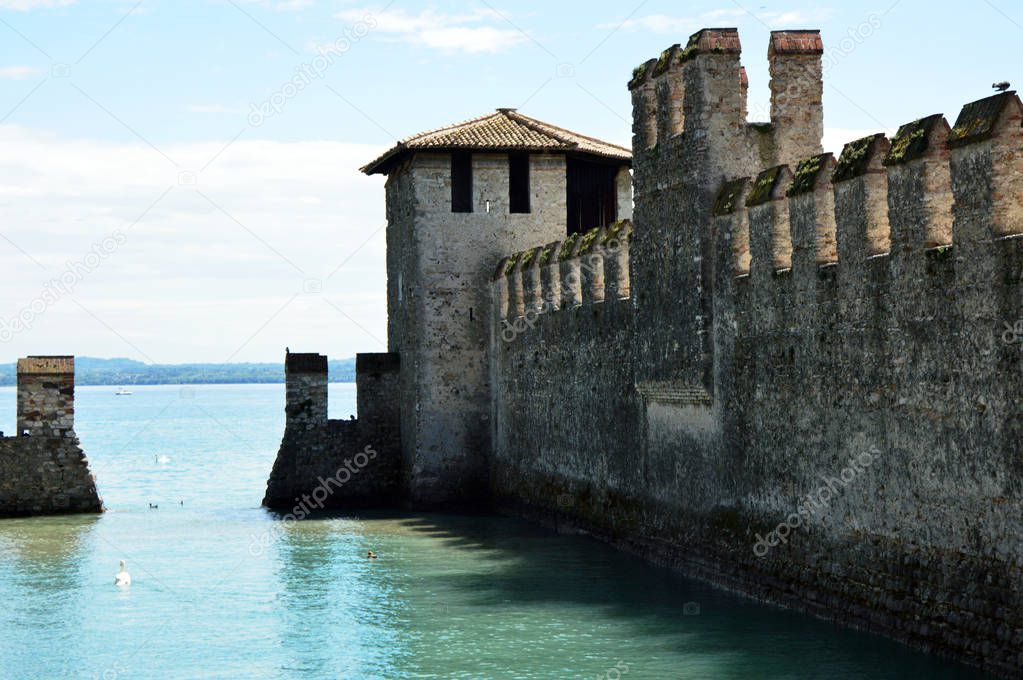 Sirmione Scaliger Castle with moat, rare example of medieval port fortification, Sirmione, Lake Garda, Italy 
