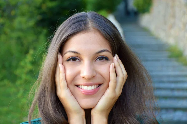 Young woman showing smile and holding her face — Stock Photo, Image