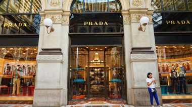 MILAN, ITALY - SEPTEMBER 7, 2017: Facade of Prada boutique inside Galleria Vittorio Emanuele II gallery, the world's oldest shopping mall, Milan, Italy  clipart