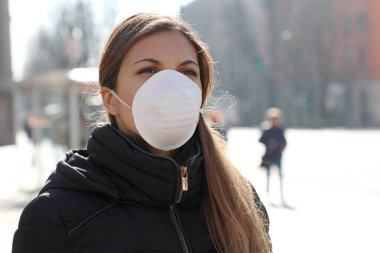 SARS-CoV-2 virüsünü yaymak için maske takan şehir sokaklarındaki COVID-19 pandemik Coronavirus kadını. Coronavirus Hastalığı 2019 'a karşı koruyucu maskeli bir kız..