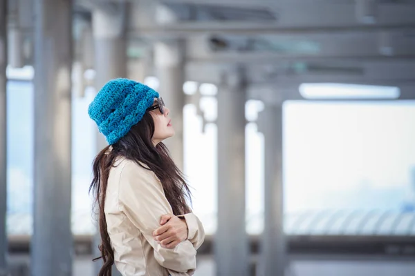 Женщина обнимает себя и смотрит прочь с зимним одиноким смайликом — стоковое фото