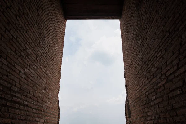 レンガの壁のトンネルと雲空の背景、日光を歩く方法 — ストック写真