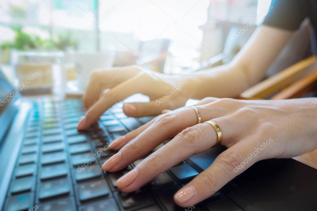 Hand on keyboard close up, business woman working on laptop 