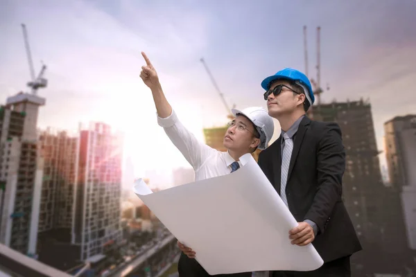 Asiatische Geschäftsmann suchen und zeigen mit dem Finger weg und Ingenieur — Stockfoto