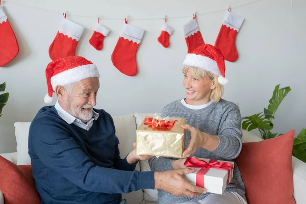 Anziano anziano caucasico vecchio uomo e donna dare regali a — Foto Stock