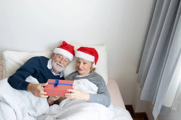Senior elderly caucasian old man give gift presents to woman, th — Stock Photo, Image