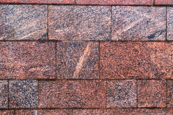 A parede de granito texturizado de sombra vermelha a marrom — Fotografia de Stock