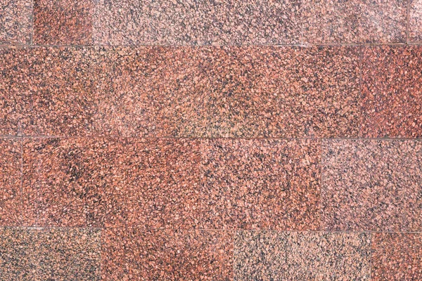 Den texturerade granit mur av röd till brun nyans — Stockfoto