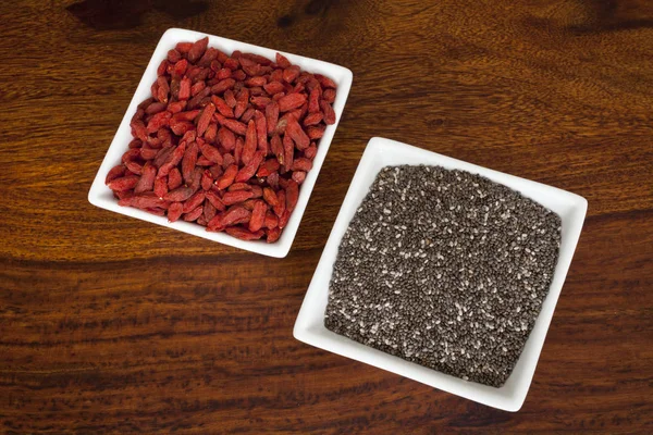 Chia and goji in bowls — Stock Photo, Image