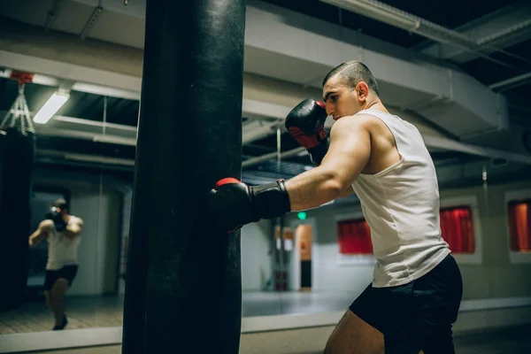 Spor salonunda boksör eğitim yumrukta yere yumruk topu yan görünüm