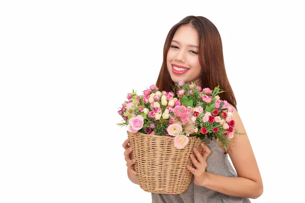 Girl holding a basket of flowers. — Stock Photo, Image