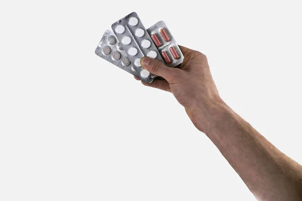 Hand met medische drugs - volledige zilveren bijsluiter van witte pillen gemeen tabletten vorm, geïsoleerd op witte achtergrond — Stockfoto