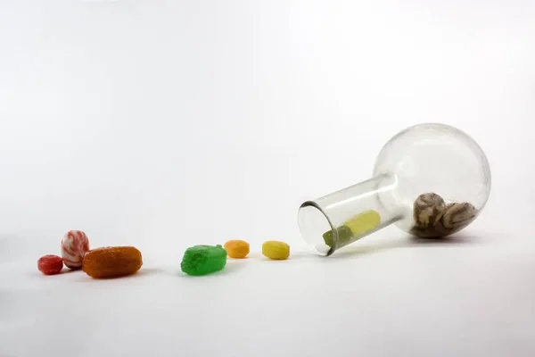 Dulces de caramelo de color en jarrón de vidrio, imagen aislada sobre un fondo blanco — Foto de Stock