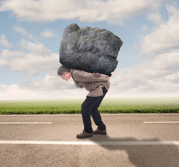 Empresário segurando uma grande rocha — Fotografia de Stock