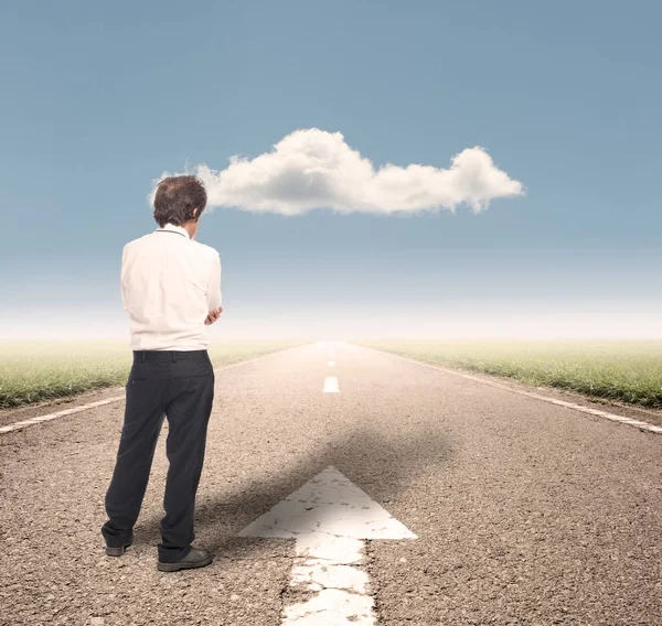 Businessman standing on a road — Stock Photo, Image