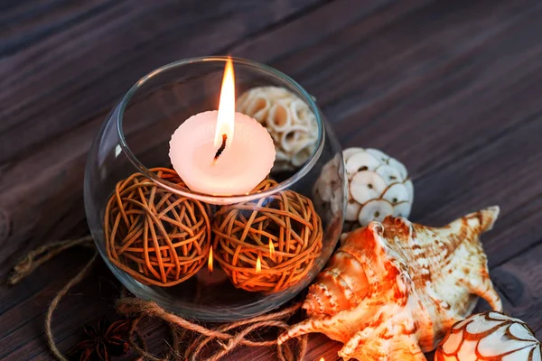 A candle in a glass vase, decoration and various interesting elements. Candles burning. — Stock Photo, Image