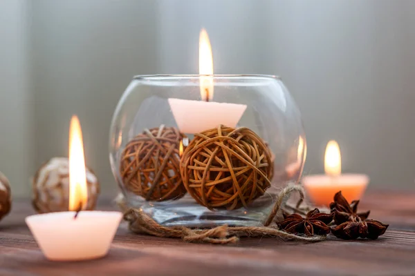 Una vela en un jarrón de vidrio, decoración y varios elementos interesantes. Velas encendidas . — Foto de Stock