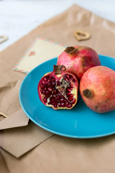 pomegranates on the kraft paper. Vegetarian food. Healthy food