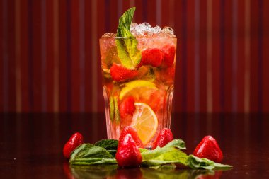 Çiğ meyve ve limon dolu bir bardaktaki horoz kuyruğu.