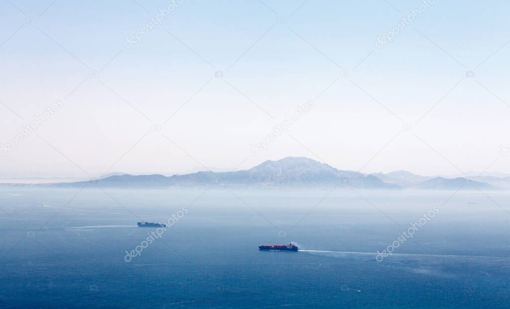 Gibraltar strait with passing tankers at sunny day