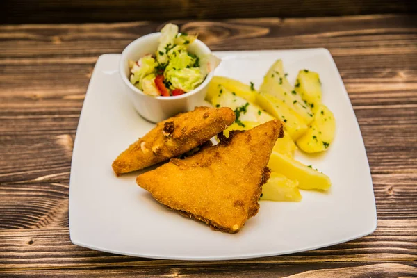 Food on a plate, on a wooden background.Food detail