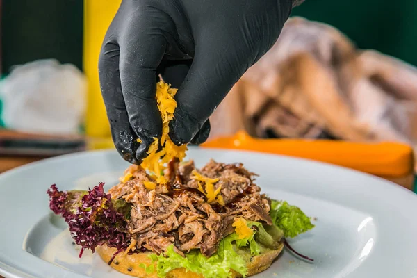 Close up hands of chef preparing fresh burger . Cooking concept