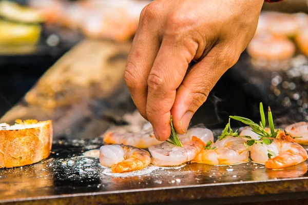 Close up hands of chef preparing food in the kitchen of a restaurant, cooking concept
