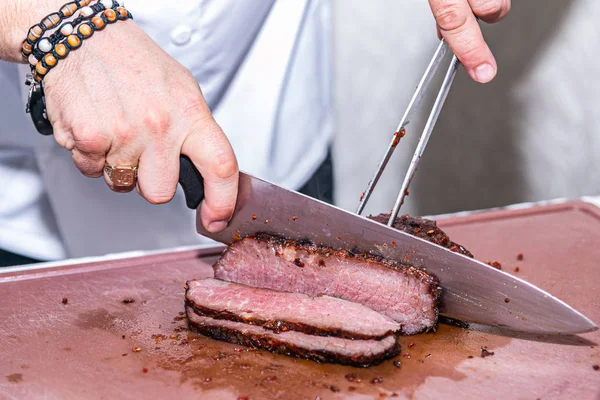 Close up hands of chef preparing food in the kitchen of a restaurant, cooking concept