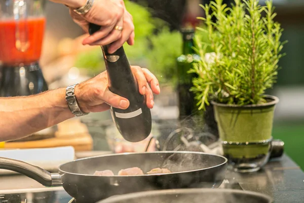 Close up hands of chef preparing food in the kitchen of a restaurant, cooking concept