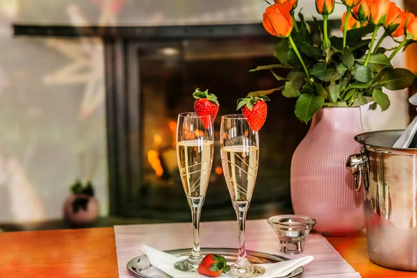 A glass with the champagne, decorated with a strawberry. Romantic composition with champagne and strawberry