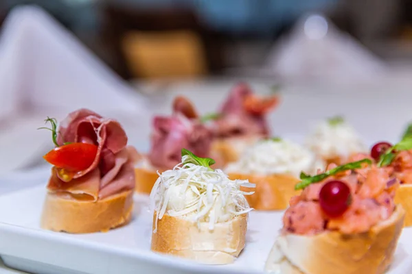 Detail of a canapes of a meal at an event, wedding, meeting or congress with food. Canapes decorated on the dish