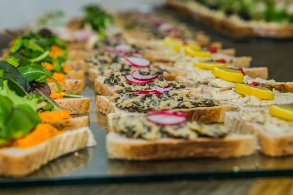 Detail of a canapes of a meal at an event, wedding, meeting or congress with food. Canapes decorated on the dish