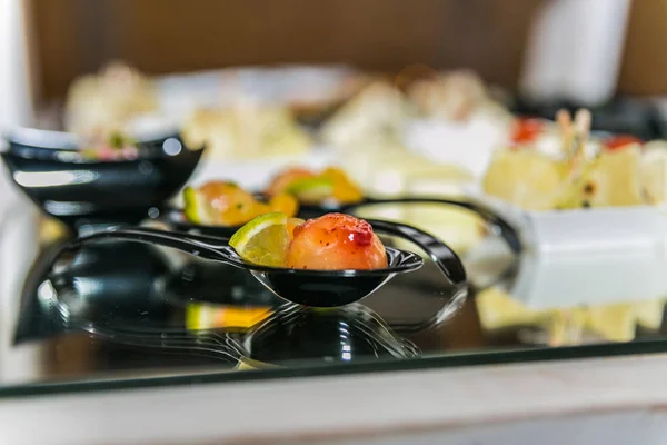Detail of a canapes of a meal at an event, wedding, meeting or congress with food. Canapes decorated on the dish
