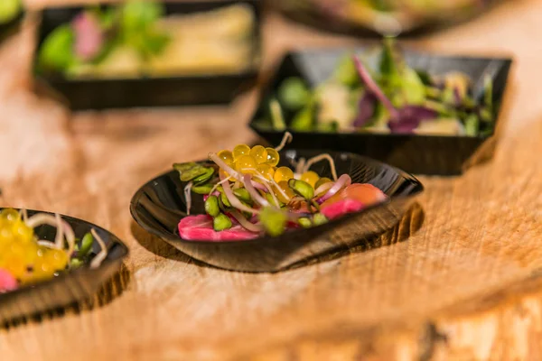 Detail of a canapes of a meal at an event, wedding, meeting or congress with food. Canapes decorated on the dish