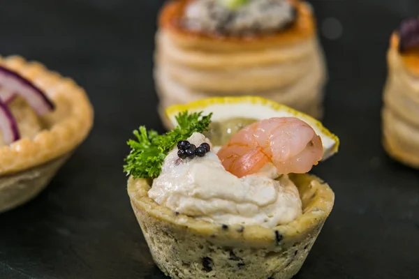 Detail of a canapes of a meal at an event, wedding, meeting or congress with food. Canapes decorated on the dish