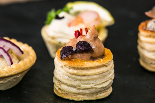 Detail of a canapes of a meal at an event, wedding, meeting or congress with food. Canapes decorated on the dish